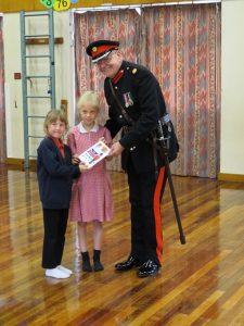 Major Stan Hardy accepting the card on behalf of HM the Queen